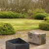 Basalt fire pit from the side. A contemporary modern metal geometric or square firepit.